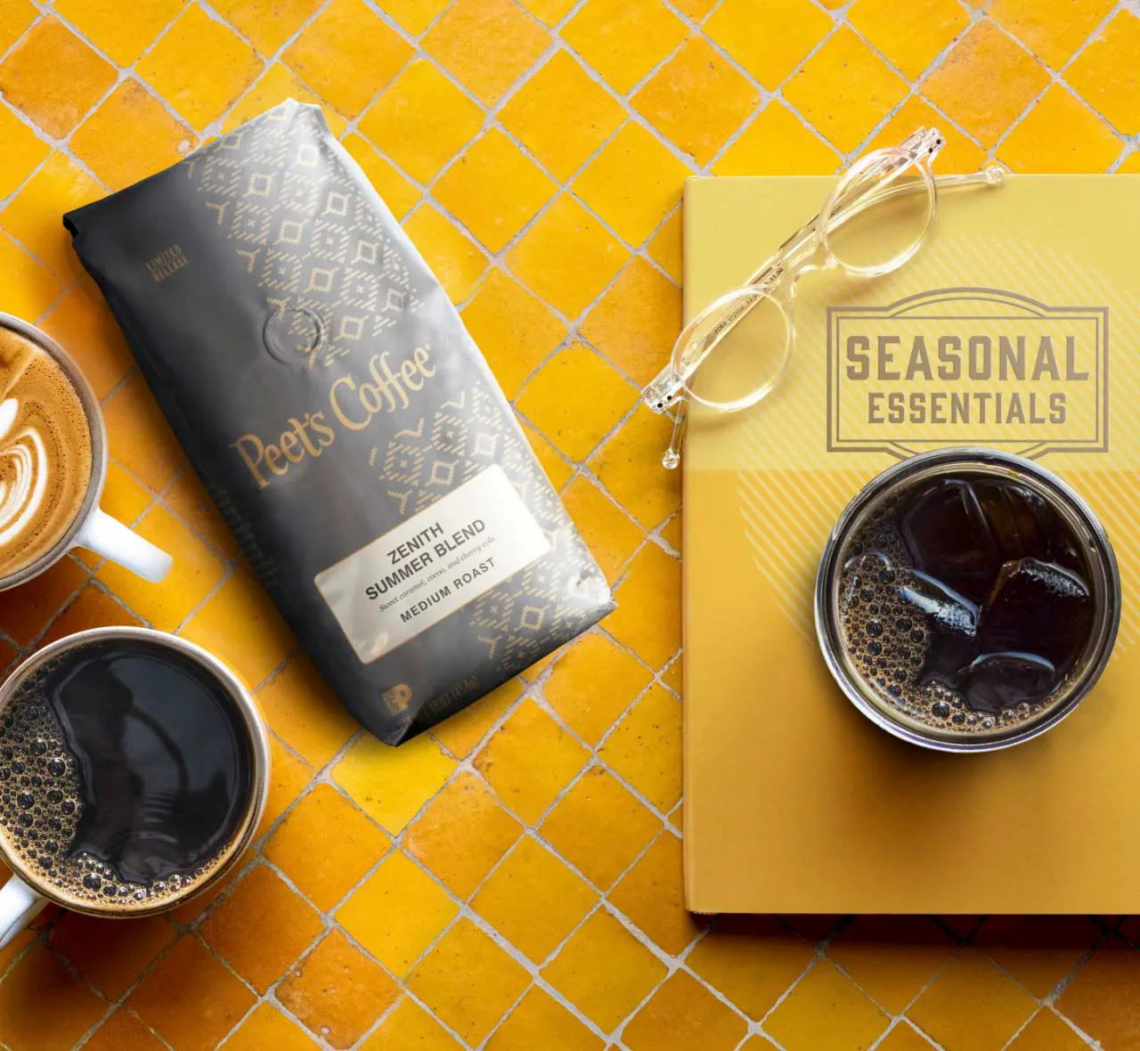 Yellow tile background with bag of Zenith beans and two cups of coffee