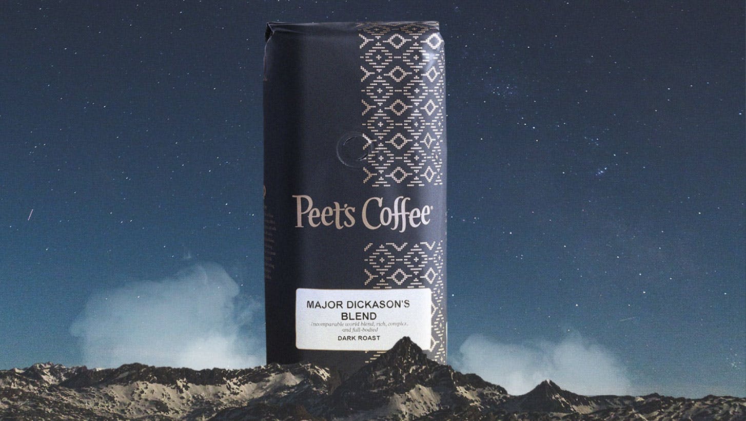 Bag of Peet's Major Dickason's coffee towering above a mountain range